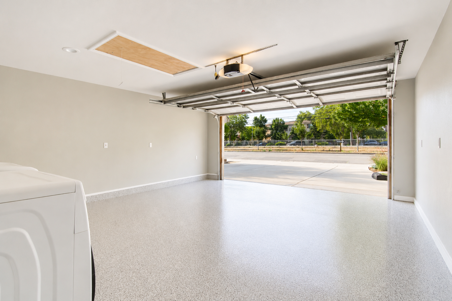 Two-car garage with epoxy floor and washer dryer
